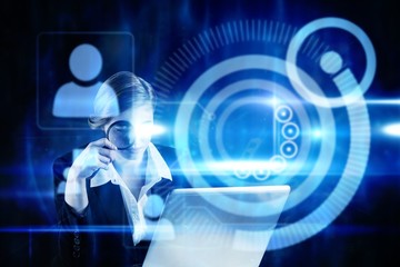 Composite image of redhead businesswoman using her laptop