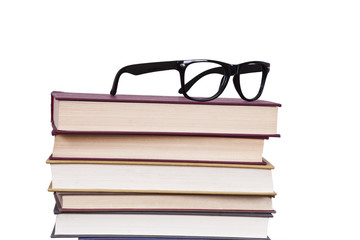 glasses above the stacked books, business and objects