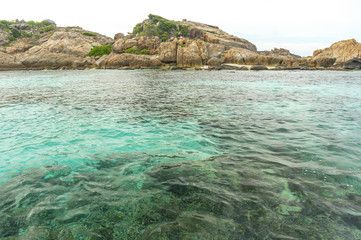 Rock island and clear water with low angle view