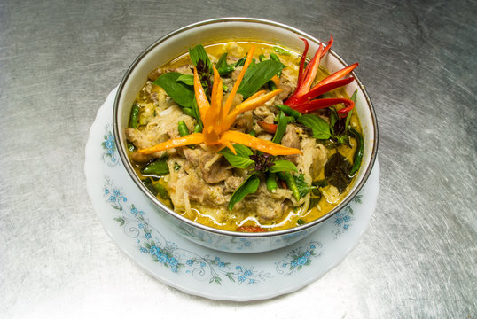 Green curry with pork and coconut is Thai cuisine.