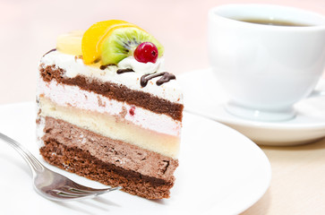 Piece of chocolate cake with fruit on plate