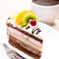 Piece of chocolate cake with fruit on plate