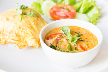 Delicious rice and red curry with pork and omelet (Thai panang c