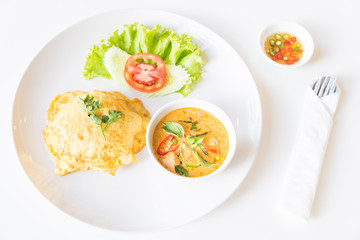 Delicious rice and red curry with pork and omelet (Thai panang c