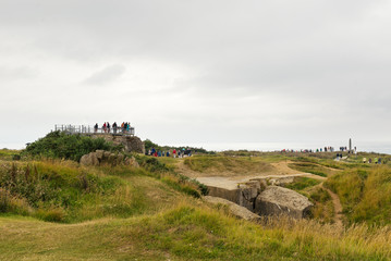 Tourists visiting German bunkers. Omaha beach, France.
