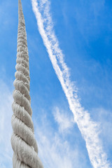 rope rises to blue sky with white clouds