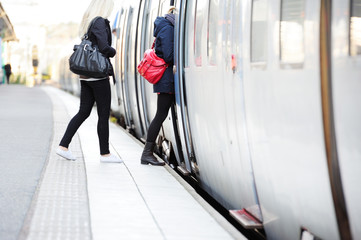 Women in hurry enters train