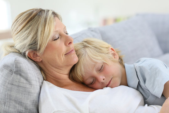 Mother And Son Asleep On Couch