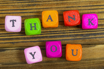 Toy letters that spell give thank you on wooden background