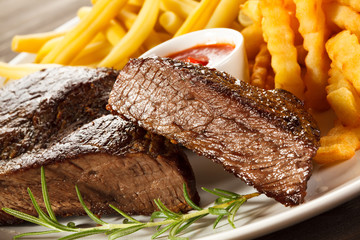Grilled steak, chips and vegetables