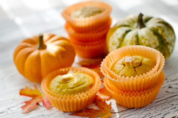 Healthy Pumpkin muffins with fresh pumpkins for autumn dessert