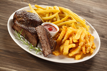 Grilled steak, chips and vegetables