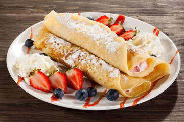 Pancakes with cream and strawberries