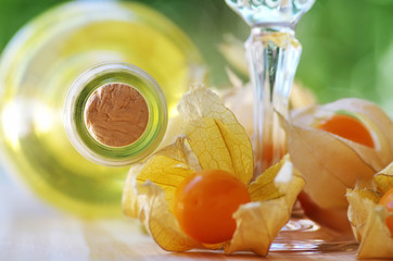 bottle of  white wine and physalis fruits