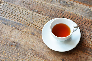 Cup with tea on the wood table.