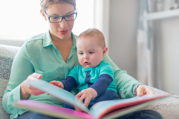 Cute baby reading with his mother - 70392078