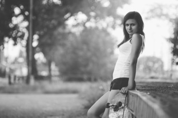 Beautiful skater girl in summer city