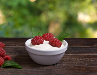 Raspberry, Mint and Cream on Wooden Table in a Village