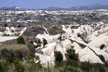 Fototapeta na wymiar Village set to unusual landscape of Cappadocia, Turkey