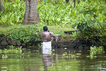 Bathing man in Backwaters, India