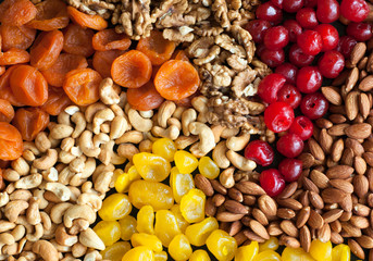 dried fruits and nuts on black background