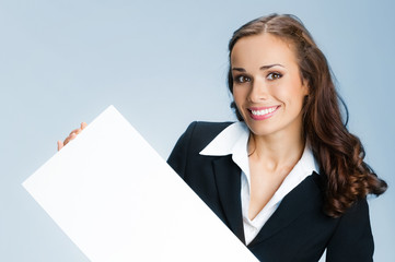 Businesswoman showing signboard, over blue