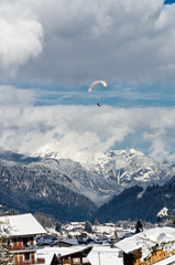 Fototapeta na wymiar Paragliders flying over the mountain