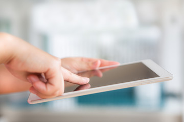 Woman hand hold white tablet with blank empty screen