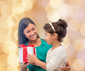 happy mother and child girl with gift box
