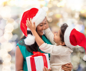 happy mother and child girl with gift box