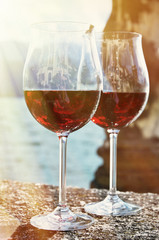 Two wineglasses against lake Como, Italy