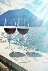 Two wineglasses against lake Como, Italy