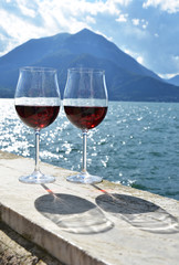 Two wineglasses against lake Como, Italy