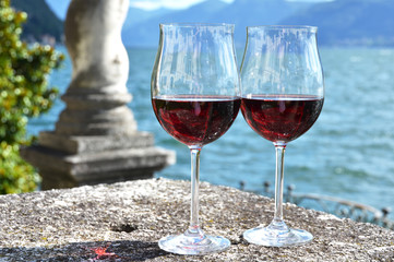 Two wineglasses against lake Como, Italy