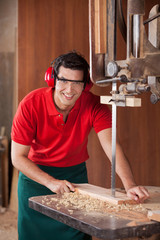 Confident Carpenter Cutting Wood With Bandsaw