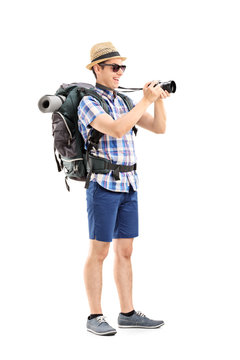 Male tourist taking picture with a camera