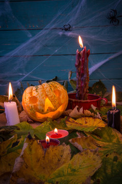 Halloween decoration with scarecrow and candles