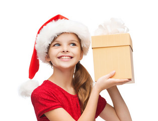 smiling girl in santa helper hat with gift box
