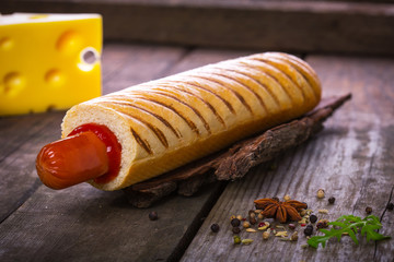 French hot dog grill on wooden surface