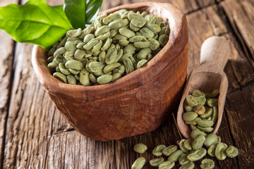 green coffee beans in wooden bowl