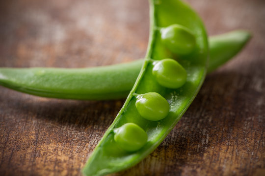 Fresh peas on wooden table