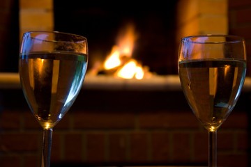 Glasses of wine in front of a fireplace