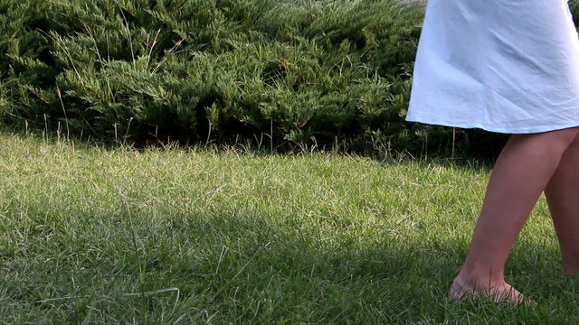 Cute baby boy making his first steps on grass