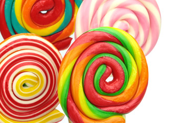Fototapeta na wymiar Colorful spiral lollipops on white background. Close-up