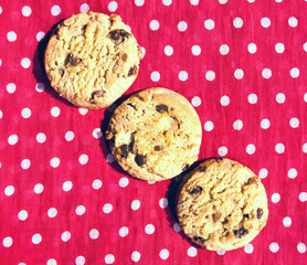 Three lined up chocolate chip cookies