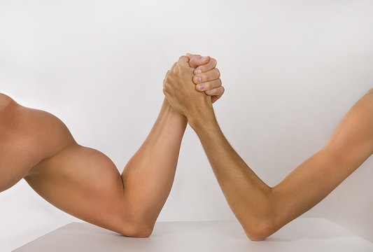 Two hands clasped arm wrestling (strong and weak), Unequal match