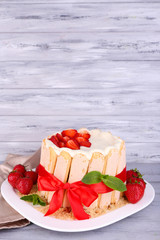 Tasty cake Charlotte with fresh strawberries on wooden table