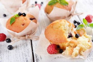 Tasty cupcakes with fruits on table close-up