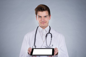 Portrait Of Confident Doctor Holding Digital Tablet