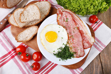 Scrambled eggs with bacon and vegetables served